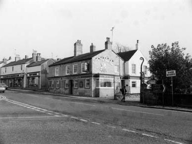 High Street from the junction with Market Place. The George and Dragon pub is in the centre, with Bridge Foot to the right of it, by the edge of Wetherby Bridge over the River Wharfe.
