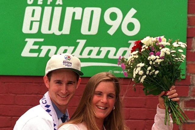 Saying it with flowers. Jonathan Davis and Fay Bourton are pictured in front of one of the Euro 96 signs at Elland Road.