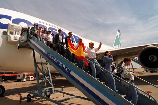 Two Spanish fans arrive along with 300 other French fans on a Boeing 747SP at Leeds Bradford Airport ahead of the Elland Road clash between the two nations.