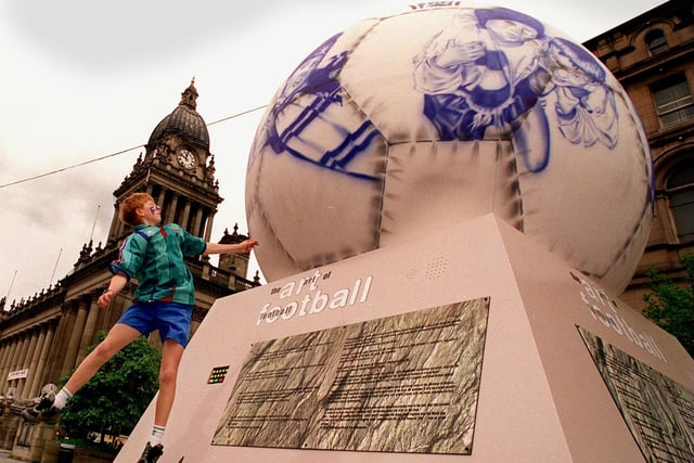 Paul Barton, a pupil at Allerton Grange High, is seen here pretending to head one of the footballs at the Art Of Football installation at Victoria Gardens.