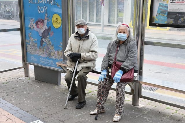 A couple wearing face masks sit at a bus stop in Corporation Street in the town centre on May 11, 2020 (Picture: Henry Iddon)