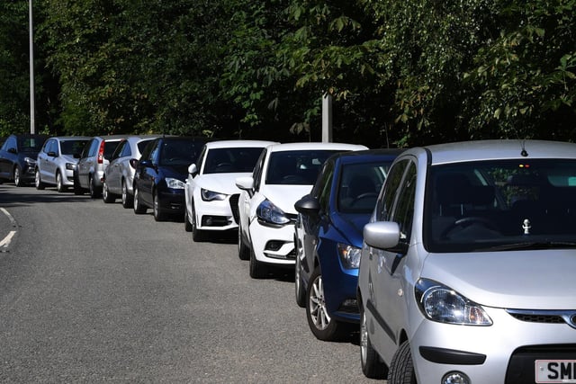 Cars parked up in Burley-in-Wharfedale as people head to the River Wharfe