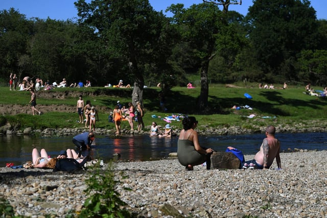 Crowds gather in Burley-in-Wharfedale as people head to the River Wharfe