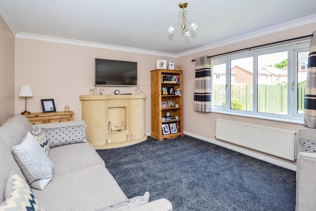 The main living room is situated at the back of the property and benefits from a large window overlooking the rear garden, central heating radiator and a feature fireplace with provision for a wall mounted television above.