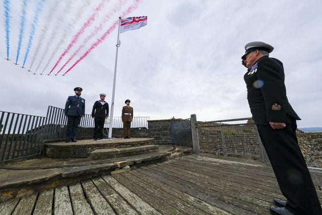Flight Sergeant John Brooke-Smith, Able Rate Ahron Reilly (HMS Calliope) from Newcastle, Private Michael Normandale (4 Yorks), with WO Terry Miller (HMS Calliope) from Newcastle giving the salute, at the flag raising ceremony in Scarborough Castle. Photo: Crown Copyright 2020.