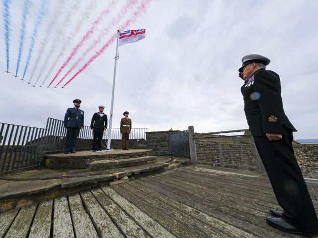 Flight Sergeant John Brooke-Smith, Able Rate Ahron Reilly (HMS Calliope) from Newcastle, Private Michael Normandale (4 Yorks), with WO Terry Miller (HMS Calliope) from Newcastle giving the salute, at the flag raising ceremony in Scarborough Castle. Photo: Crown Copyright 2020.