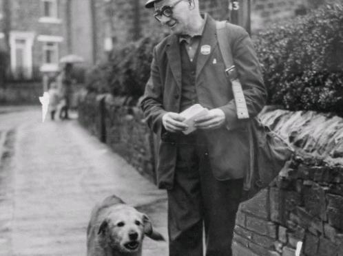 Postman Percy Gorman on his round at Pudsey with Rex, who has accompanied him for six years.