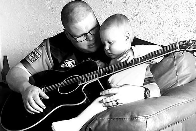 Danielle Atherton sent in:
My husband teaching my son Regan the guitar