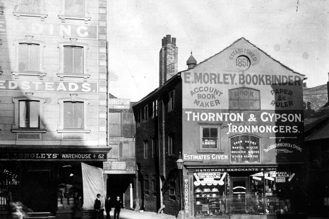 Lands Lane in Leeds city centre. Thornton and Gypson, ironmongers on the right. People in the street.