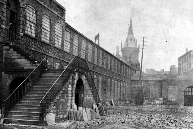 Looking towards entrance of Coloured Cloth Hall Yard with the spire of Royal Exchange building, City Square in the background. Demolished 1889.
