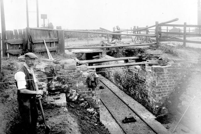 Construction of bridge over railway line which served Osmondthorpe Colliery. To the right is a chimney, this was part of the Leeds Industrial Co-operative Society laundry, located on Osmondthorpe Lane.