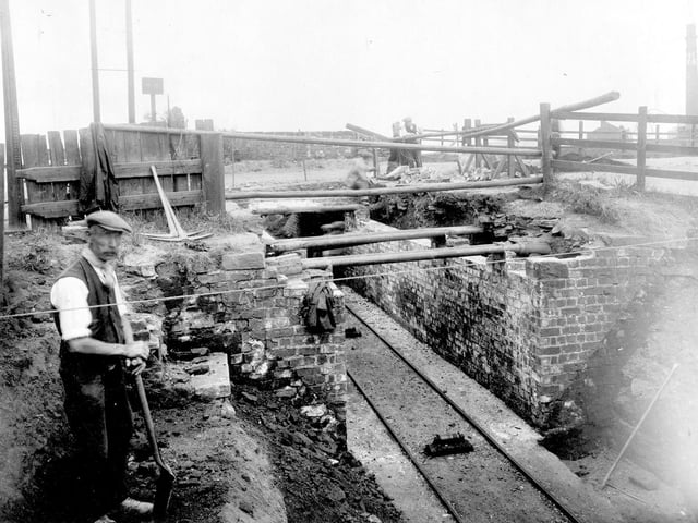Construction of bridge over railway line which served Osmondthorpe Colliery. To the right is a chimney, this was part of the Leeds Industrial Co-operative Society laundry, located on Osmondthorpe Lane.