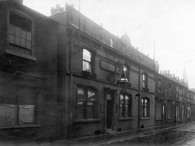 Row of shops, most of which are taken up by the premises of Sarah Ann Lee, beer retailer.