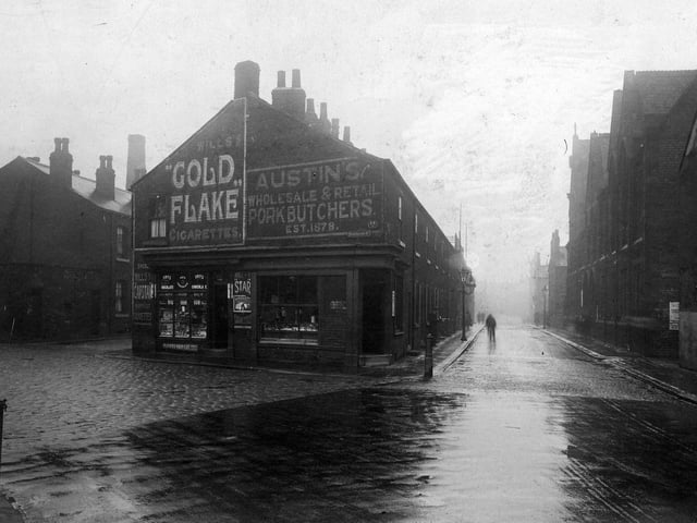 Domestic Street, right, at the junction with Sydenham Street, left. The two shops visible are numbers 52 Domestic Street, Harry Schofield's grocers (left) and 50 Domestic Street, Misses Martha and Betty Austin, Pork Butchers.