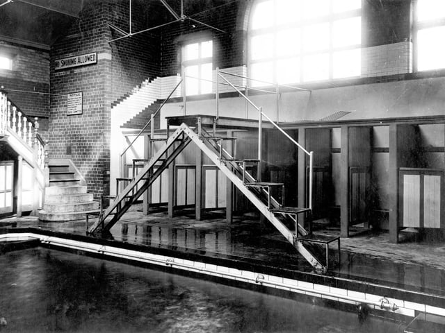 Located on Holbeck Lane, the baths were opened in 1898 and closed in 1979. This view shows the swimming pool with diving platform. To the left, steps leading to a spectators balcony with changing cubicles underneath.