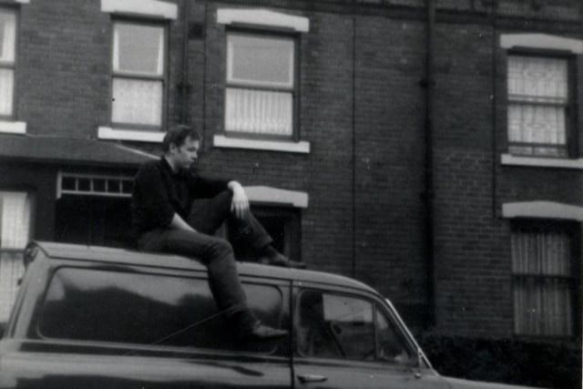 View of Colenso Grove showing a man sitting on top of a Ford Anglia van.