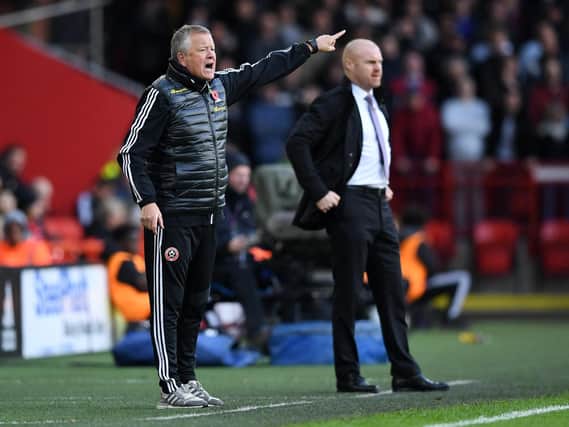 Chris Wilder, manager of Sheffield United, reacts during the Premier League match between Sheffield United and Burnley FC as Clarets boss Sean Dyche watches on at Bramall Lane on November 02, 2019 in Sheffield, United Kingdom. (Photo by Nathan Stirk/Getty Images)