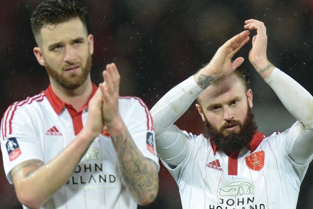 David Edgar (L) and John Brayford (R) applaud the fans at the end of the English FA Cup third-round football match between Manchester United and Sheffield United at Old Trafford in north west England on January 9, 2016. AFP PHOTO / OLI SCARFF