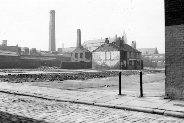 Photo taken from behind Carpenters Arms on Stone Row, showing housing clearance on Camp Fields. It shows the Bricklayers pub on Middle Row and the Victoria Wheel and Wagon works in the background with St. Francis of Assisi school.