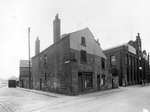 View looking south west at the corner of Derwent Street and Water Lane. Knight and Forster Ltd. printers and F. Coggill and Son stockists and distributing agents visible. Simpson's Ready Food truck on the left.
