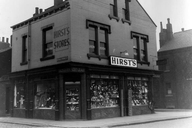 A view showing Walter Hirst stores at numbers 24 to 26 Beeston Road, a double fronted shop with upstairs store rooms selling household goods.