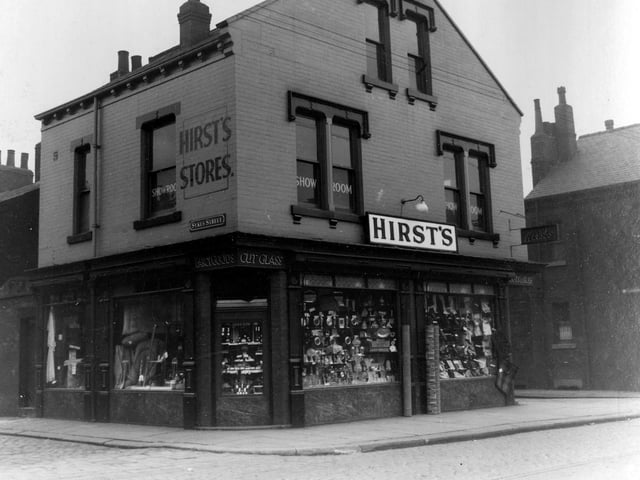 A view showing Walter Hirst stores at numbers 24 to 26 Beeston Road, a double fronted shop with upstairs store rooms selling household goods.