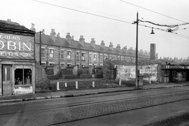 A view looking north through the gap between number 42, Staychrome electro plating Co, and number 52, a tobacconist on Elland Road towards Elland Terrace. The buildings in between have been demolished.