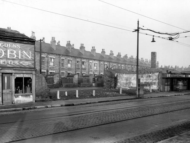 A view looking north through the gap between number 42, Staychrome electro plating Co, and number 52, a tobacconist on Elland Road towards Elland Terrace. The buildings in between have been demolished.