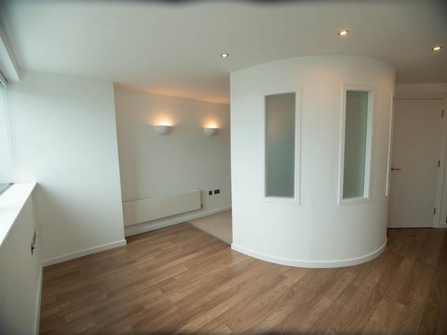 The bright and airy living area is to the left of the kitchen dining area.
