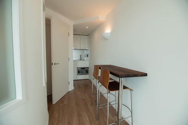 The dining area is a small breakfast bar worktop located near to the kitchen.