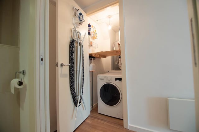 Built in store cupboard housing hot water tank and automatic washer/dryer.