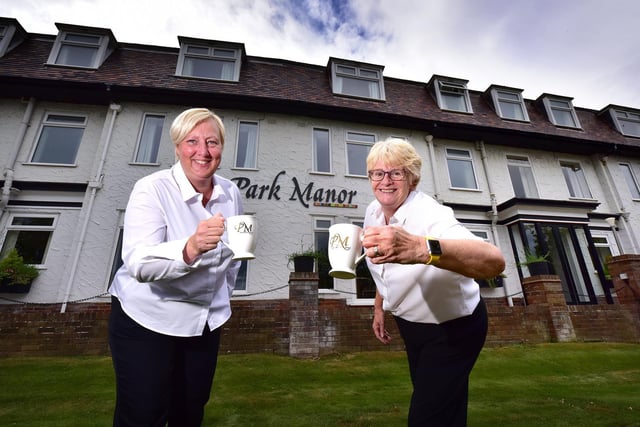 Making a toast with tea ... Park Manor Hotel staff Mags McNaught and Ali Lockwood celebrate.
