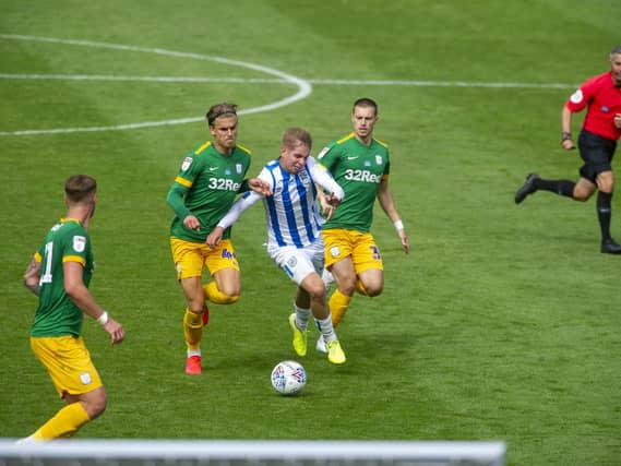 Brad Potts checks the run of Huddersfield substitute Emile Smith Rowe