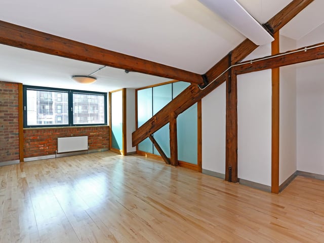 The huge space has lots of light and is a complete blank canvas. (Non-virtually staged photo of living area.)