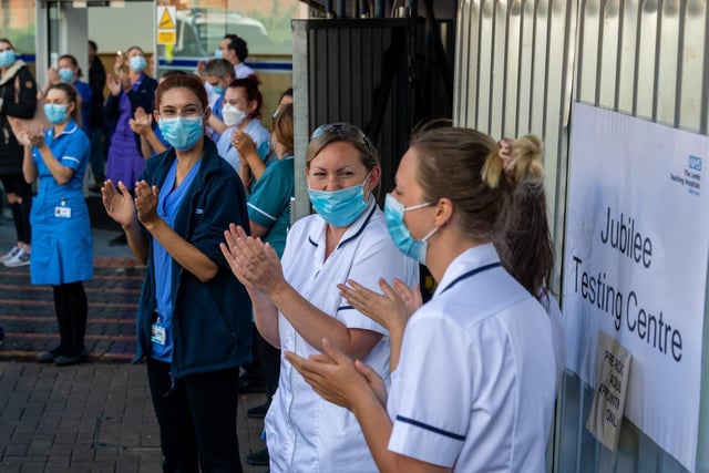NHS workers standing united outside the Jubilee Wing of Leeds General Infirmary, to give the NHS their biggest final applaud.