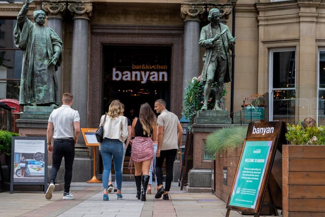 A group of friends entering Banyan, City Square, Leeds.