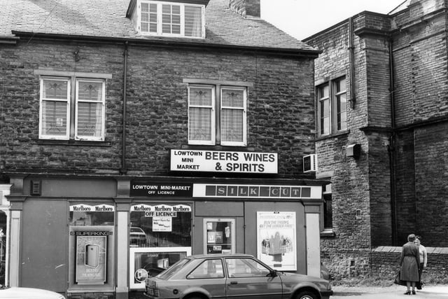 Did you shop here back in the day? Lowtown Mini-Market. It is also an off-licence with 'Beers, Wines & Spirits' advertised prominently along with several cigarette brands.