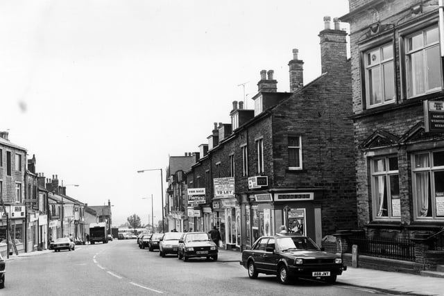 Lowtown. On the right is Pudsey Liberal Club then a row of shops in ascending order which include Lowtown Mini-Market, Walkers & Wharfedale Windows, Doors and Patios and A.E. Smith, radio engineer.