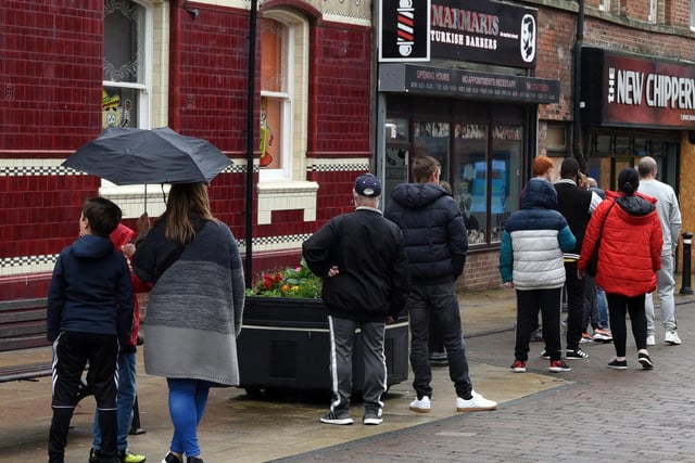 Queues for a barbers shop, Market Street, Wigan town centre.