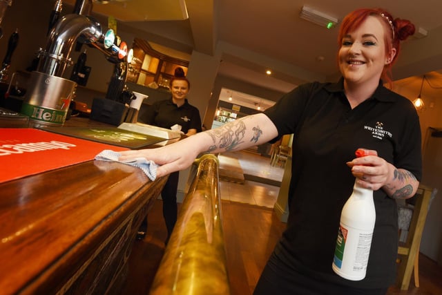 Fiona Campbell cleaning ready for customers at The Whitesmiths Arms, Standishgate, Wigan.