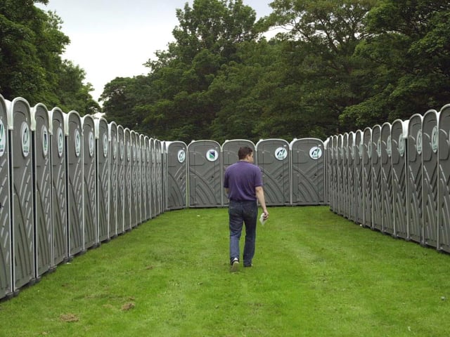 A wokeman checks the hundreds of portable toilets ahead of the start of the event.
