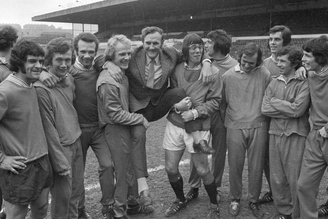 Don Revie and his players celebrate winning the title.