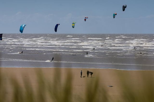 Walkers stopped to marvel at the kites as they walked on the beach