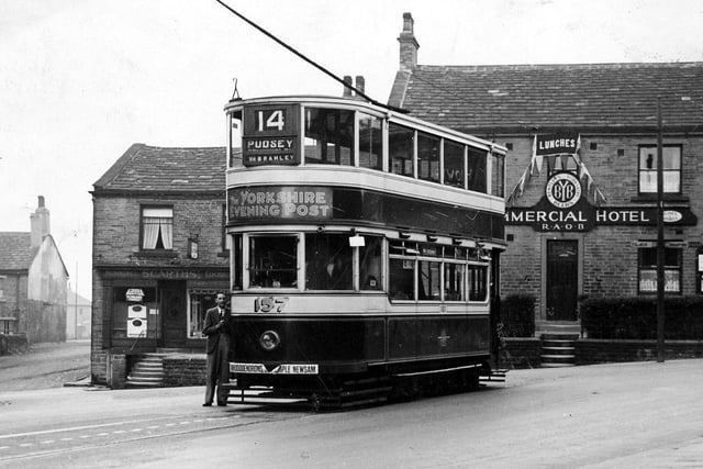 A view of a Horsfield no. 157 tram at Pudsey terminus on Chapeltown. An advert for the YEP can be seen on the front. Behind the tram are the Commercial Hotel on the right and Scarths, plumbers and electricians, to the left.