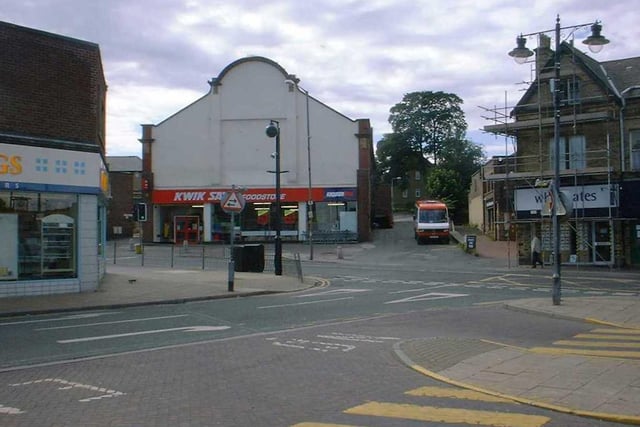 Church Lane taken from Market Place where the bus station is located. The white-rendered building housing Kwik Save is the former Pudsey Picture House which opened in November 1920.