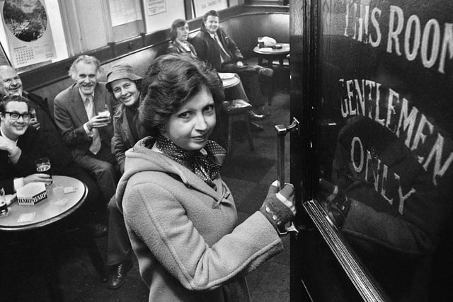 Student Marilyn Evans enters the gentlemen only bar in the Market Hotel, Mesnes Street, Wigan, on Monday 29th of December 1975, the first day of the new equality act for women.  For 50 years men only had crossed the threshold of the exclusively male only bar in the Wigan pub but the Sex Discrimination Act changed all that.