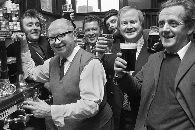 Landlord Colin Cook and regulars at the Market Hotel in Wigan in 1974.