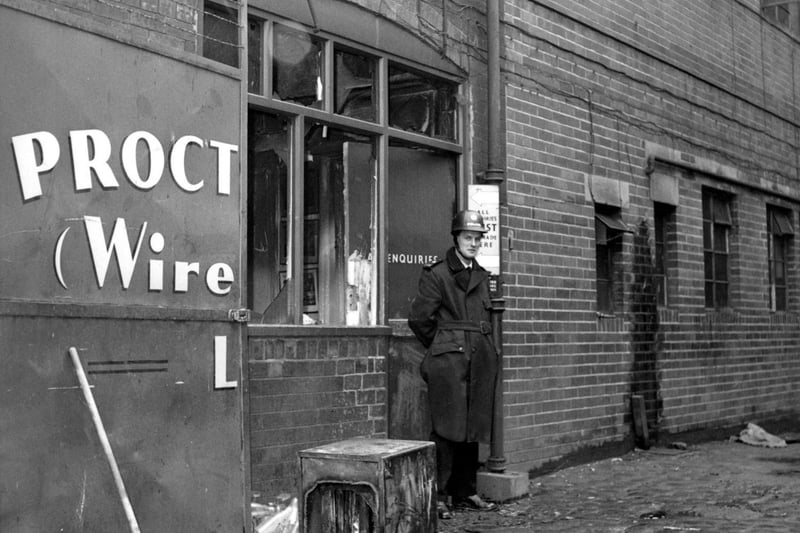 Proctor Brothers (Wireworks) factory after a break-in and arson. The thieves had lit ten fires, burning company records, and stealing money from the safe. A policeman stands outside the enquiries office.