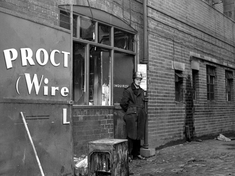 Proctor Brothers (Wireworks) factory after a break-in and arson. The thieves had lit ten fires, burning company records, and stealing money from the safe. A policeman stands outside the enquiries office.