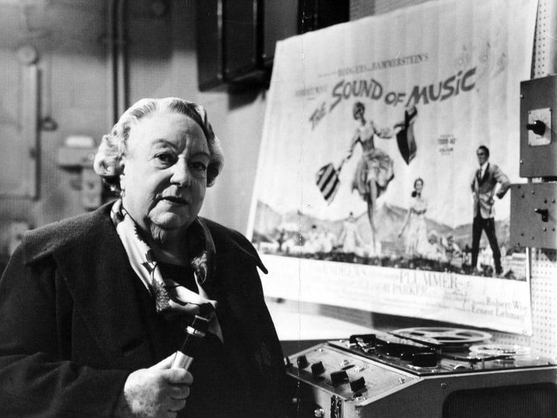 Pictured in the projection room of the Majestic Cinema, Madame Lilian Stiles-Allen the soprano, records a message of congratulation for Julie Andrews, star of The Sound of Music on the second anniversary of the film.